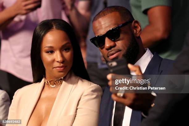 Player Lebron James and wife Savannah Brinson attends the super welterweight boxing match between Floyd Mayweather Jr. And Conor McGregor on August...