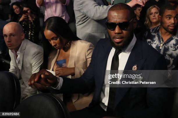Player Lebron James and wife Savannah Brinson attends the super welterweight boxing match between Floyd Mayweather Jr. And Conor McGregor on August...