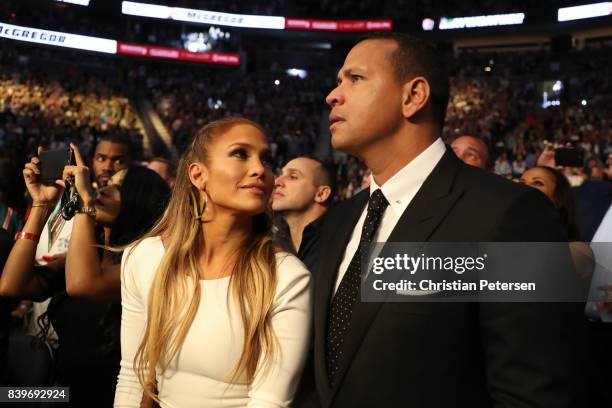 Actress Jennifer Lopez and former MLB player Alex Rodriguez attend the super welterweight boxing match between Floyd Mayweather Jr. And Conor...