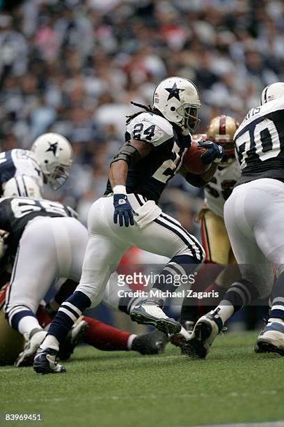Marion Barber of the Dallas Cowboys runs with the ball during an NFL football game against the San Francisco 49ers at Texas Stadium on November 23,...