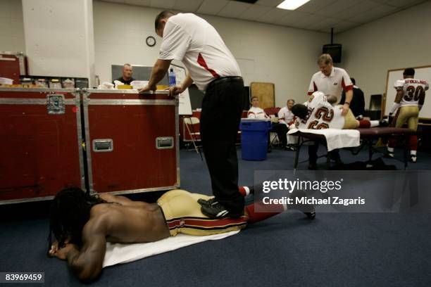 Vernon Davis of the San Francisco 49ers is stretched in the locker room before an NFL football game against the Dallas Cowboys at Texas Stadium on...