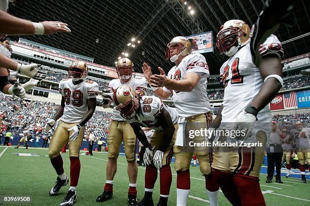 Members of the San Francisco 49ers huddle during an NFL football game against the Dallas Cowboys at Texas Stadium on November 23, 2008 in Irving,...
