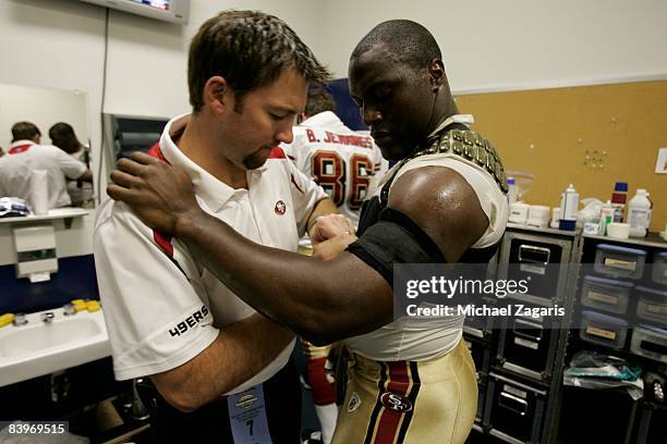 Takeo Spikes of the San Francisco 49ers is taped in the locker room before an NFL football game against the Dallas Cowboys at Texas Stadium on...