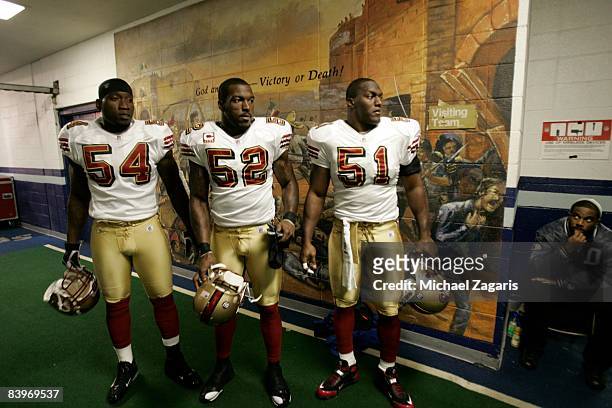 Roderick Green, Patrick Willis and Takeo Spikes of the San Francisco 49ers prepare to enter the field before an NFL football game against the Dallas...