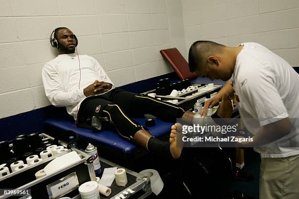 Manny Rivera tapes Bryant Johnson of the San Francisco 49ers in the locker room before an NFL football game against the Dallas Cowboys at Texas...