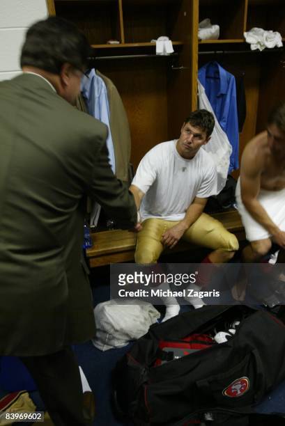 Dr. John York, owner of the San Francisco 49ers, greets Shaun Hill in the locker room after an NFL football game against the Dallas Cowboys at Texas...