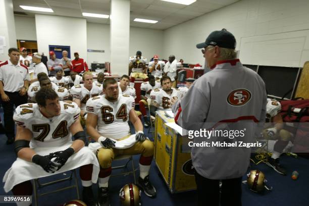 Mike Martz addresses the offensive line of the San Francisco 49ers in the locker room at halftime during an NFL football game against the Dallas...