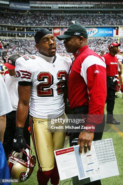 Head Coach Mike Singletary meets with Nate Clements of the San Francisco 49ers during an NFL football game against the Dallas Cowboys at Texas...