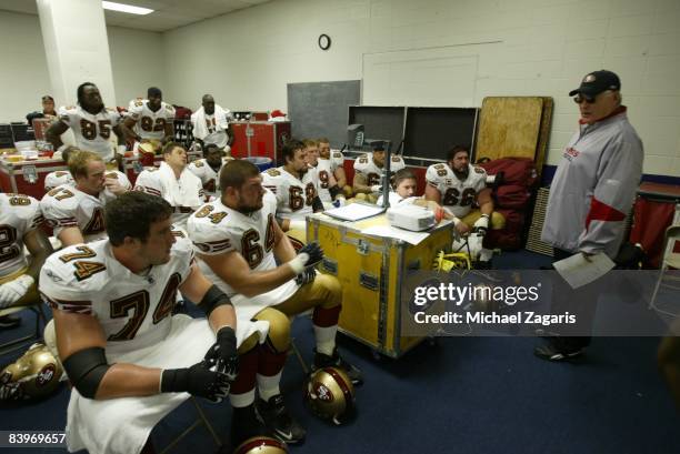 Mike Martz addresses the offensive line of the San Francisco 49ers in the locker room at halftime during an NFL football game against the Dallas...