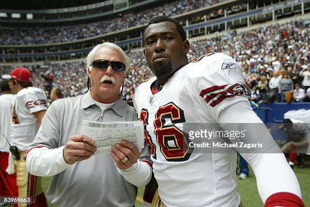 Al Everest meets with Delanie Walker of the San Francisco 49ers during an NFL football game against the Dallas Cowboys at Texas Stadium on November...