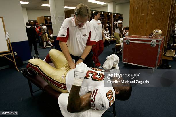 Chilo Rachal of the San Francisco 49ers is stretched in the locker room before an NFL football game against the Dallas Cowboys at Texas Stadium on...