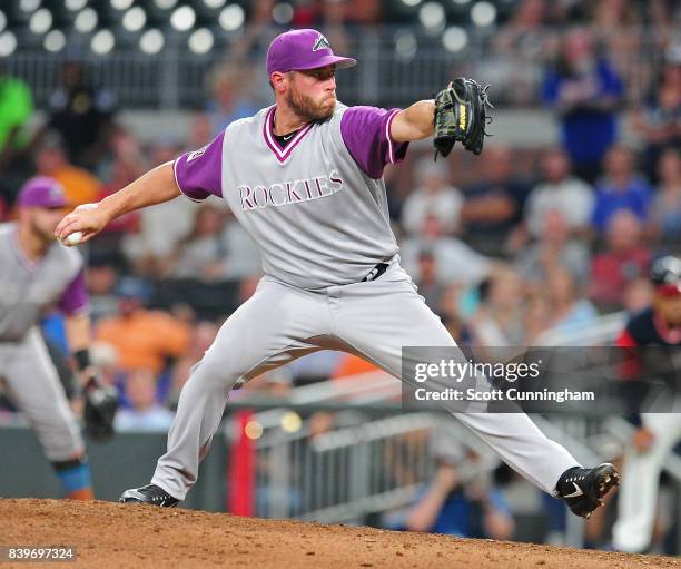 Greg Holland of the Colorado Rockies throws a ninth inning pitch against the Atlanta Braves at SunTrust Park on August 26, 2017 in Atlanta, Georgia.