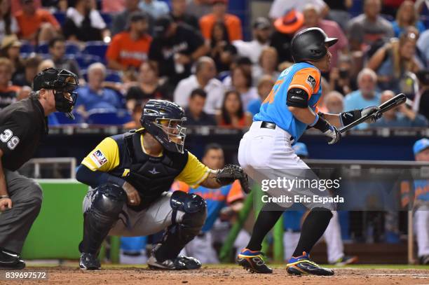 Ichiro Suzuki of the Miami Marlins squares up to bunt during his at bat in the seventh inning against the San Diego Padres at Marlins Park on August...