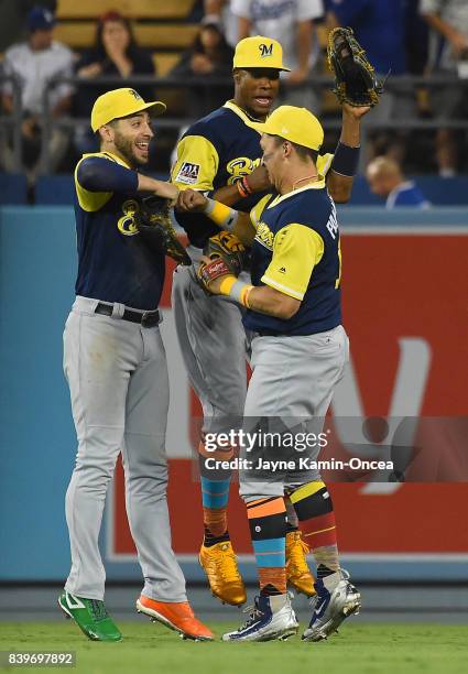 Outfielders Ryan Braun, Domingo Santana and Hernan Perez of the Milwaukee Brewers celebrate after defeating the Los Angeles Dodgers at Dodger Stadium...