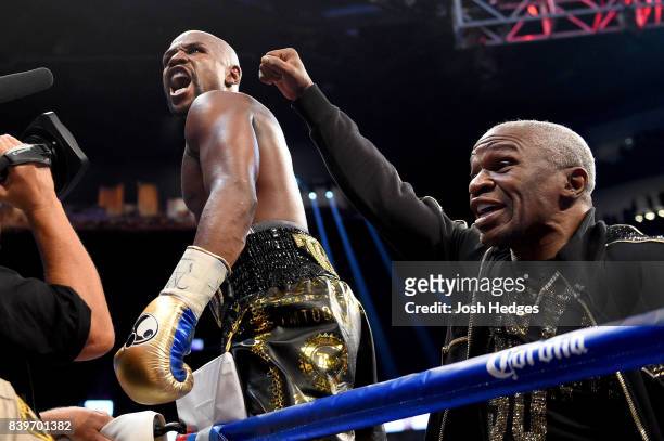 Floyd Mayweather Jr. And Floyd Mayweather Sr. Celebrate after defeating Conor McGregor during their super welterweight boxing match on August 26,...
