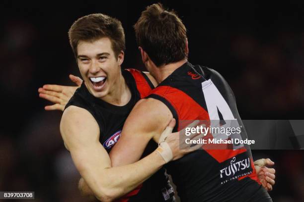 Zach Merrett of the Bombers celebrates a goal with Jobe Watson of the Bombers during the round 23 AFL match between the Essendon Bombers and the...