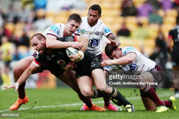 Simon Mannering of the Warriors is tackled by Shaun Lane of the Sea Eagles during the round 25 NRL match between the New Zealand Warriors and the...