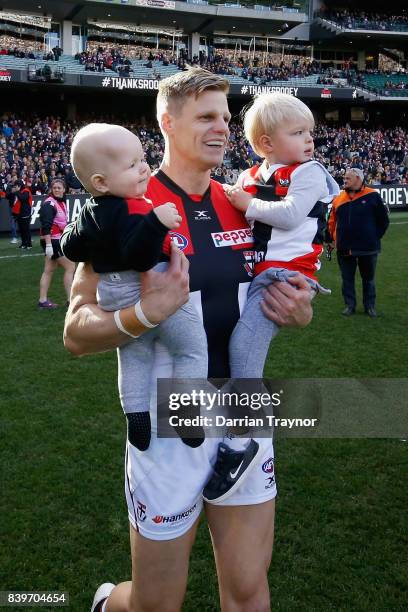 Nick Riewoldt of the Saints runs onto the ground with his sons William and James before the round 23 AFL match between the Richmond Tigers and the St...