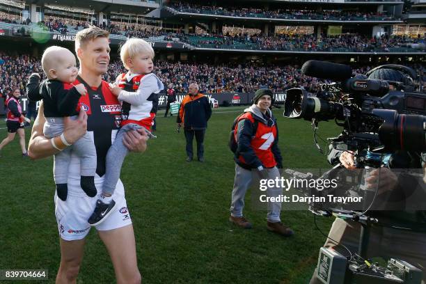 Nick Riewoldt of the Saints runs onto the ground with his sons William and James before the round 23 AFL match between the Richmond Tigers and the St...