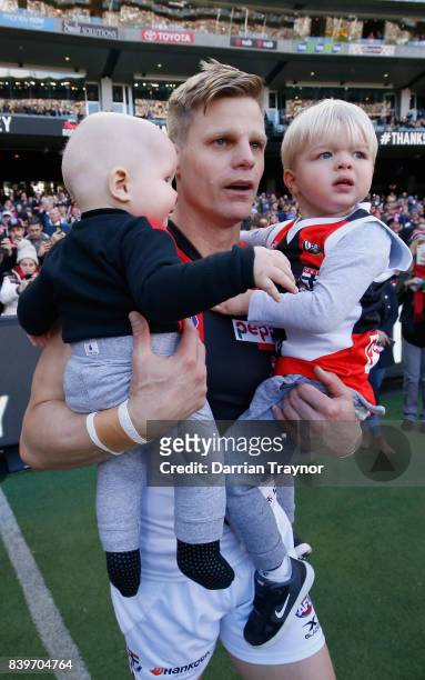 Nick Riewoldt of the Saints runs onto the ground with his sons William and James before the round 23 AFL match between the Richmond Tigers and the St...