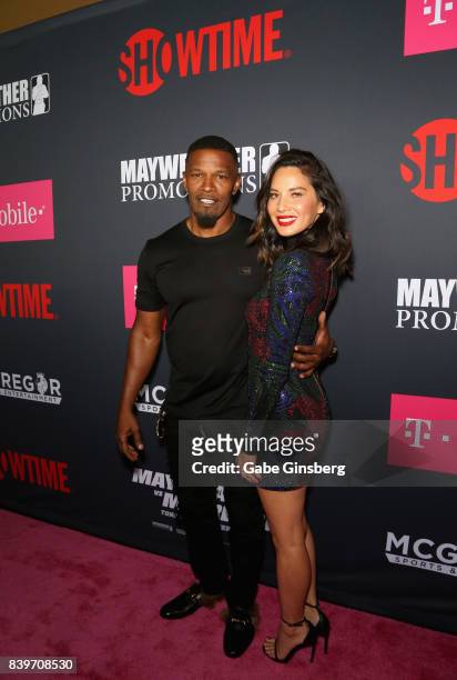 Actor Jamie Foxx and Actress Olivia Munn arrived on T-Mobile's magenta carpet duirng the Showtime, WME IME and Mayweather Promotions VIP Pre-Fight...