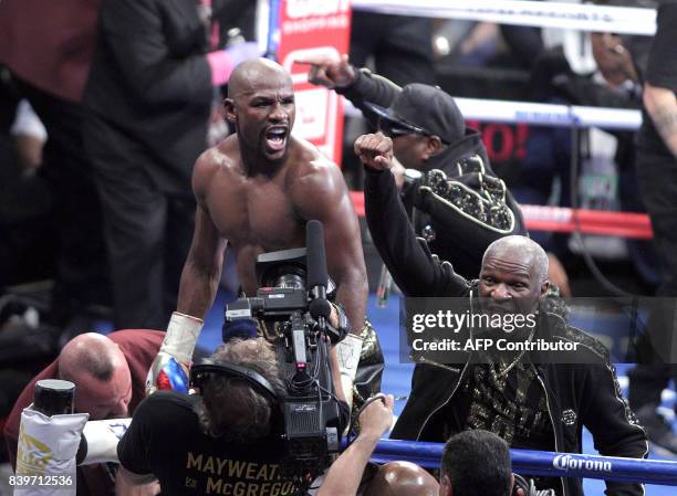 Boxer Floyd Mayweather Jr. And his father Floyd Mayweather Sr. Celebrate his 10th round TKO victory over mixed martial arts star Conor McGregor at...