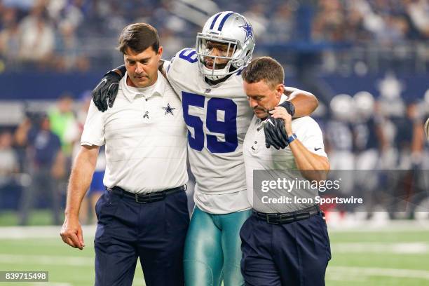 Dallas Cowboys middle linebacker Anthony Hitchens is helped off the field after an apparent knee injury late in 2nd quarter of the NFL preseason game...