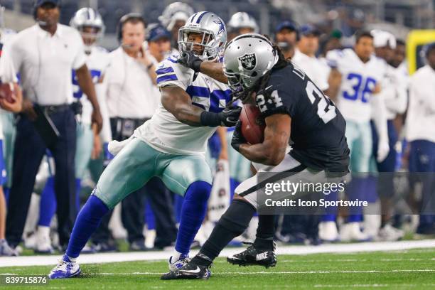 Dallas Cowboys middle linebacker Anthony Hitchens is stiff armed by Oakland Raiders running back Marshawn Lynch during the NFL preseason game between...