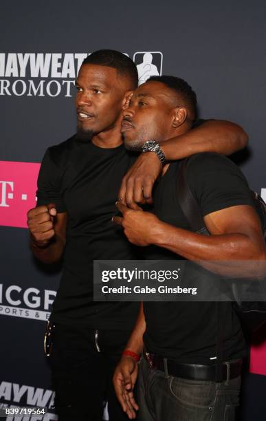 Actor Jamie Foxx and guest arrive on T-Mobile's magenta carpet duirng the Showtime, WME IME and Mayweather Promotions VIP Pre-Fight Party for...