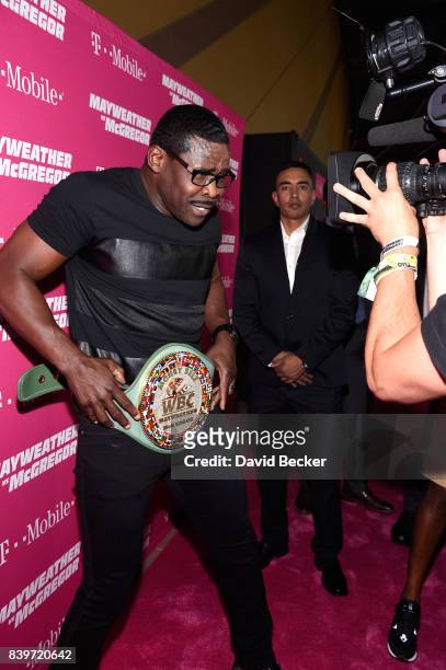 Former NFL player Michael Irvin poses with the WBC Money Belt on T-Mobile's magenta carpet duirng the Showtime, WME IME and Mayweather Promotions VIP...