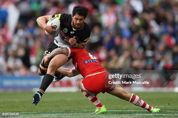 Corey Harawira Naera of the Panthers is tackled by Gareth Widdop of the Dragons during the round 25 NRL match between the Penrith Panthers and the St...
