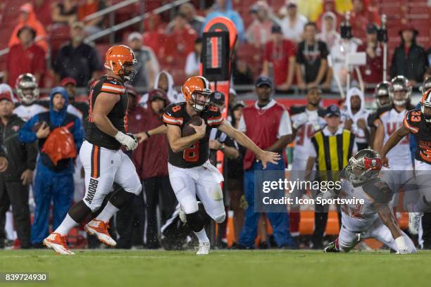 Cleveland Browns quarterback Kevin Hogan scrambles away from Tampa Bay Buccaneers linebacker Cameron Lynch during an NFL preseason football game...