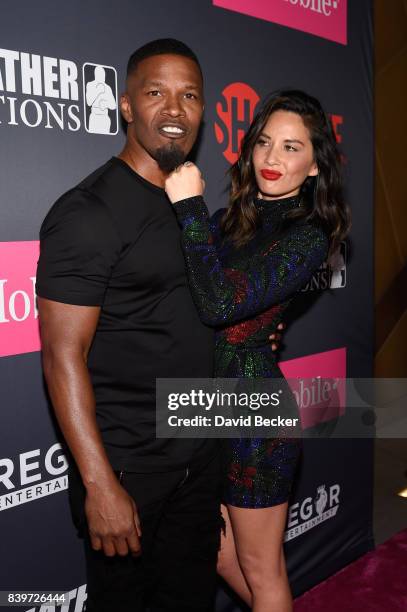 Actors Jamie Foxx and Olivia Munn arrive on T-Mobile's magenta carpet duirng the Showtime, WME IME and Mayweather Promotions VIP Pre-Fight Party for...