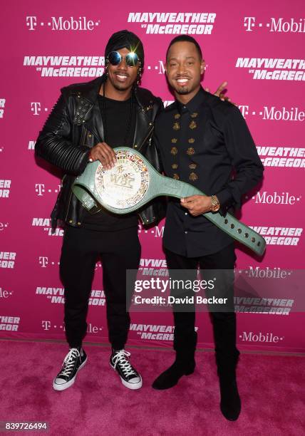 Rapper Nick Cannon and actor Terrence J pose with the WBC Money Belt on T-Mobile's magenta carpet duirng the Showtime, WME IME and Mayweather...