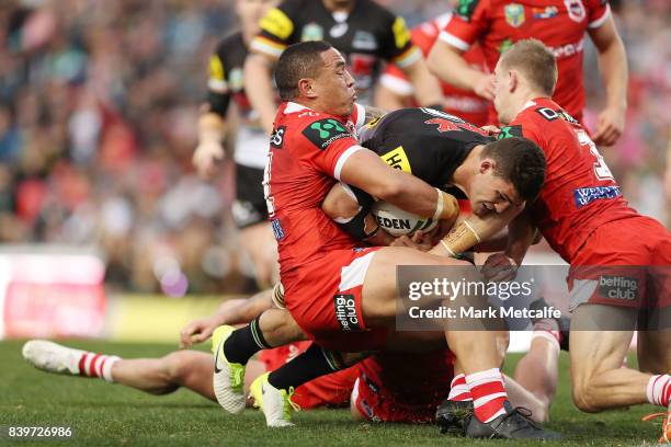 Nathan Cleary of the Panthers is tackled by Tyson Frizell of the Dragons during the round 25 NRL match between the Penrith Panthers and the St George...