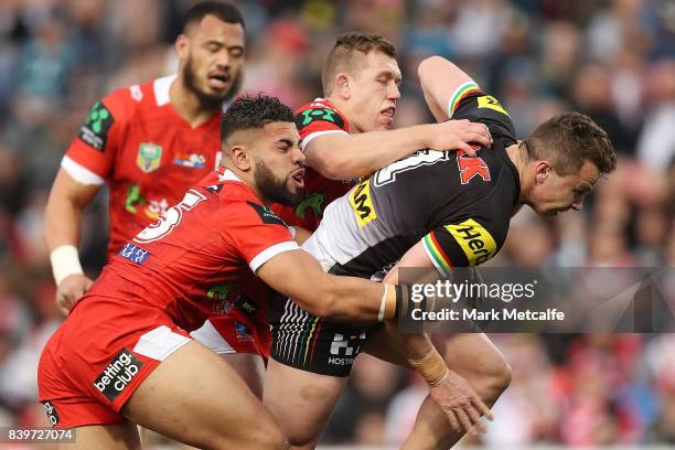 Dylan Edwards of the Panthers is tackled during the round 25 NRL match between the Penrith Panthers and the St George Illawarra Dragons at Pepper...