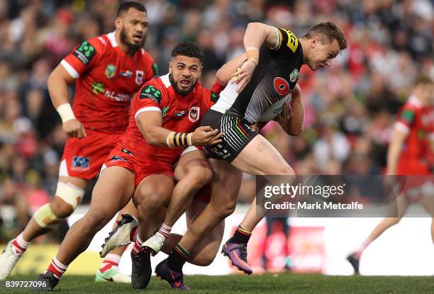 Dylan Edwards of the Panthers is tackled during the round 25 NRL match between the Penrith Panthers and the St George Illawarra Dragons at Pepper...