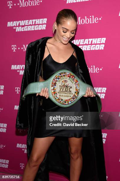 Actor Jasmine Sanders poses with the WBC Money Belt on T-Mobile's magenta carpet duirng the Showtime, WME IME and Mayweather Promotions VIP Pre-Fight...