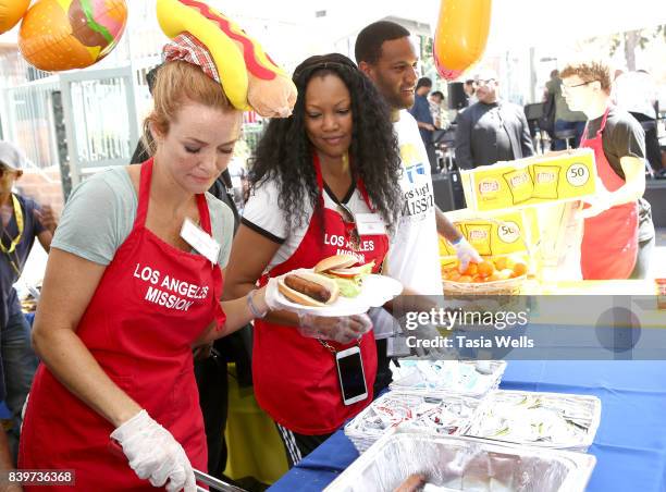 Garcelle Beauvais and son Oliver Saunders volunteer at the Los Angeles Mission's End of Summer Arts and Education Fair at Los Angeles Mission on...