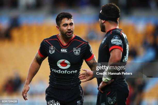 Shaun Johnson talks to Jazz Tevaga of the Warriors during the round 25 NRL match between the New Zealand Warriors and the Manly Sea Eagles at Mt...