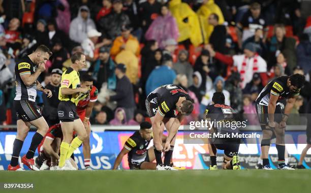 Panthers players look dejected after defeat during the round 25 NRL match between the Penrith Panthers and the St George Illawarra Dragons at Pepper...