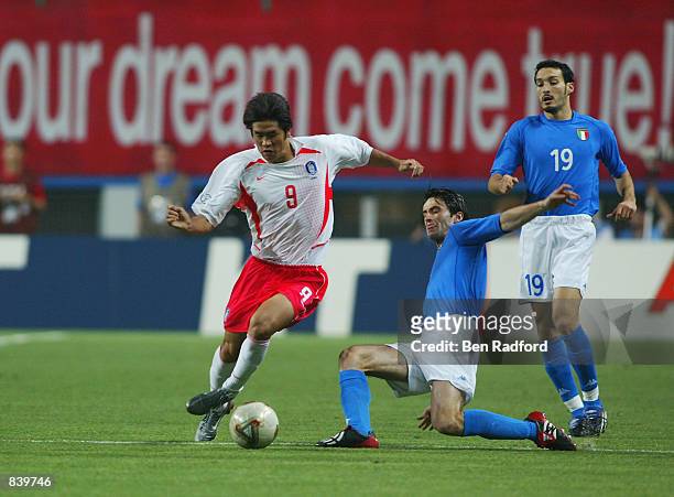 Hyeon Seol Ki of South Korea takes the ball past Christian Panucci of Italy during the FIFA World Cup Finals 2002 Second Round match played at the...