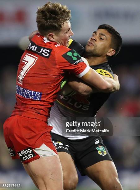 Tyrone Peachey of the Panthers is tackled by Kurt Mann of the Dragons during the round 25 NRL match between the Penrith Panthers and the St George...