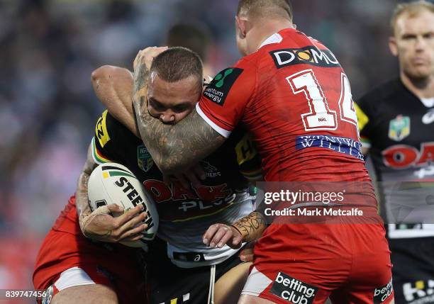 James Fisher-Harris of the Panthers is tackled during the round 25 NRL match between the Penrith Panthers and the St George Illawarra Dragons at...
