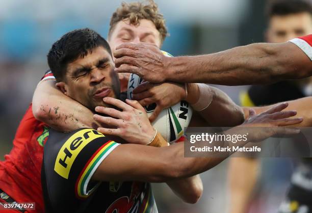 Tyrone Peachey of the Panthers is tackled by Kurt Mann of the Dragons during the round 25 NRL match between the Penrith Panthers and the St George...