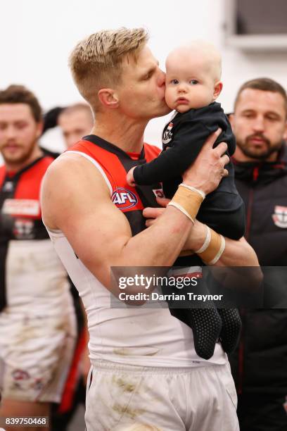 Nick Riewoldt of the Saints holds his son William in the rooms after the round 23 AFL match between the Richmond Tigers and the St Kilda Saints at...