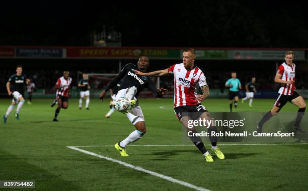 West Ham United's Diafra Sakho and Cheltenham Town's Jordon Forster during the Carabao Cup Second Round match between Cheltenham Town and West Ham...