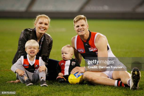 Nick Riewoldt sits on the M.C.G. With his wife Catherine and sons James and William after playing his final game the round 23 AFL match between the...