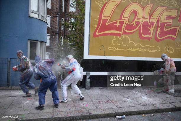 Paint-covered revellers take part in the traditional "J'ouvert" opening parade of the Notting Hill carnival on August 27, 2017 in London, England.