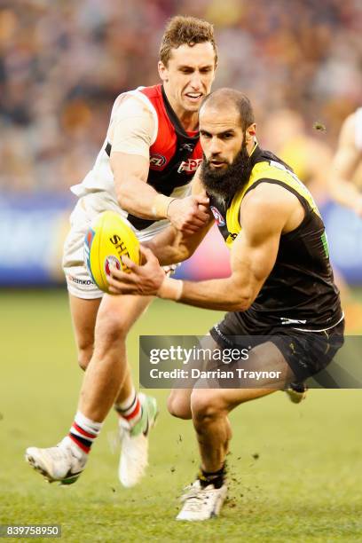 Luke Dunstan of the Saints chases Bachar Houli of the Tigers during the round 23 AFL match between the Richmond Tigers and the St Kilda Saints at...